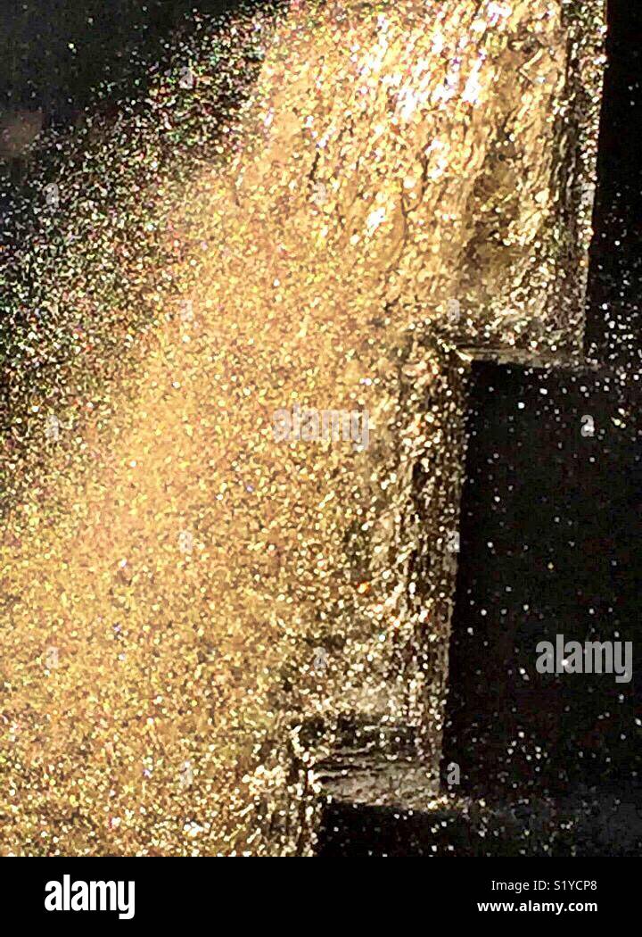 A waterfall sparkles in the sunlight at the Fort Worth Water Gardens. - Smartphone Captured Stock Image