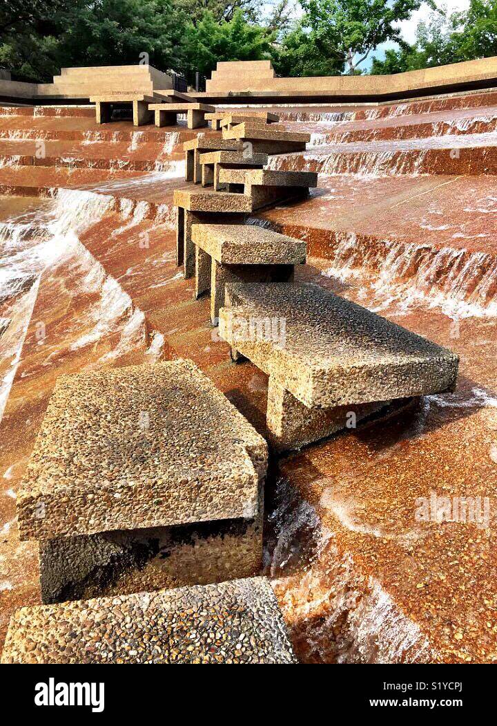 Water falls 38 feet over terraces into the eye of the active pool at the Fort Worth Water Gardens. The active pool has a path that allows visitors to experience the feel the heart of a cataract. - Smartphone Captured Stock Image