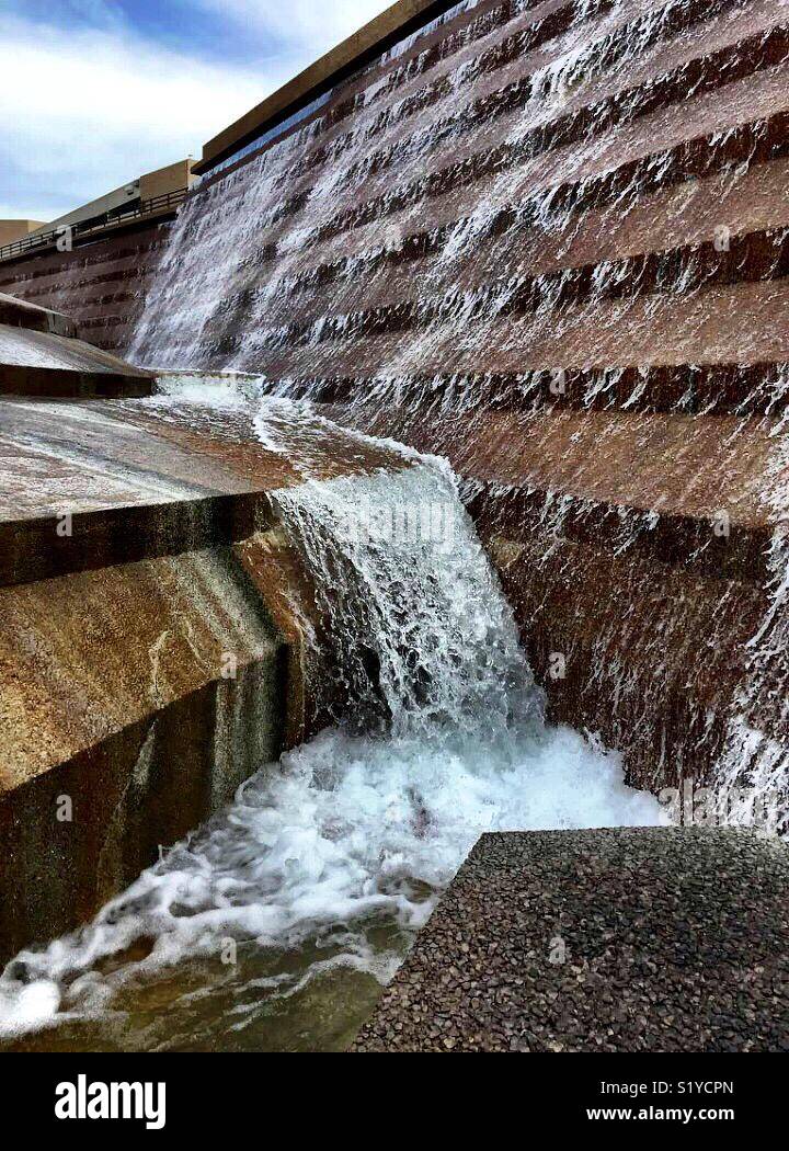 Water falls 38 feet over terraces into the eye of the active pool at the Fort Worth Water Gardens. - Smartphone Captured Stock Image