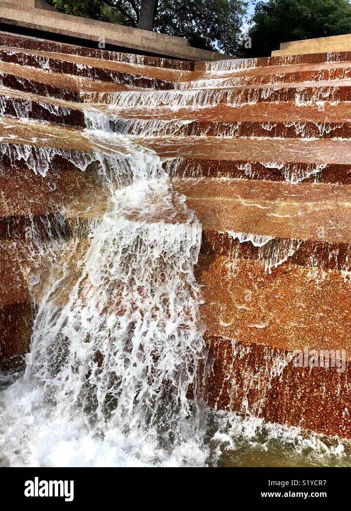 Water falls 38 feet over terraces into the eye of the active pool at the Fort Worth Water Gardens. - Smartphone Captured Stock Image