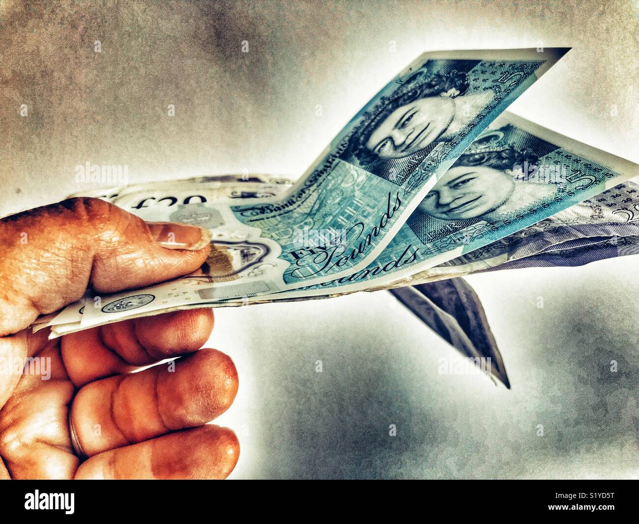 Hand holding English banknotes - Smartphone Captured Stock Image