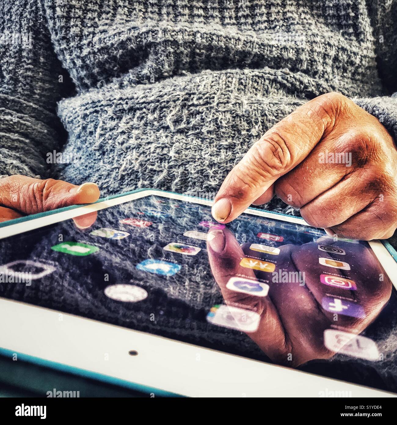 Senior man using the touch screen on the homepage of an iPad - Smartphone Captured Stock Image
