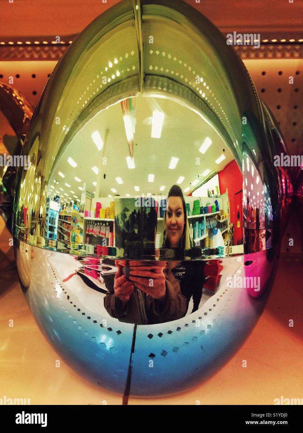 Taking selfies in oversized mirrored easter egg at Target store Stock Photo