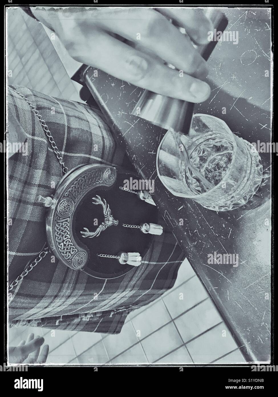 Man in kilt pouring a malt whiskey. - Smartphone Captured Stock Image