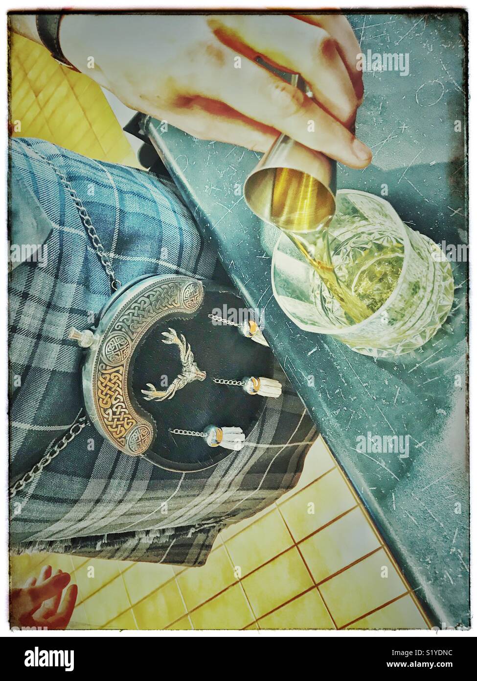Man in kilt pouring a malt whiskey. - Smartphone Captured Stock Image