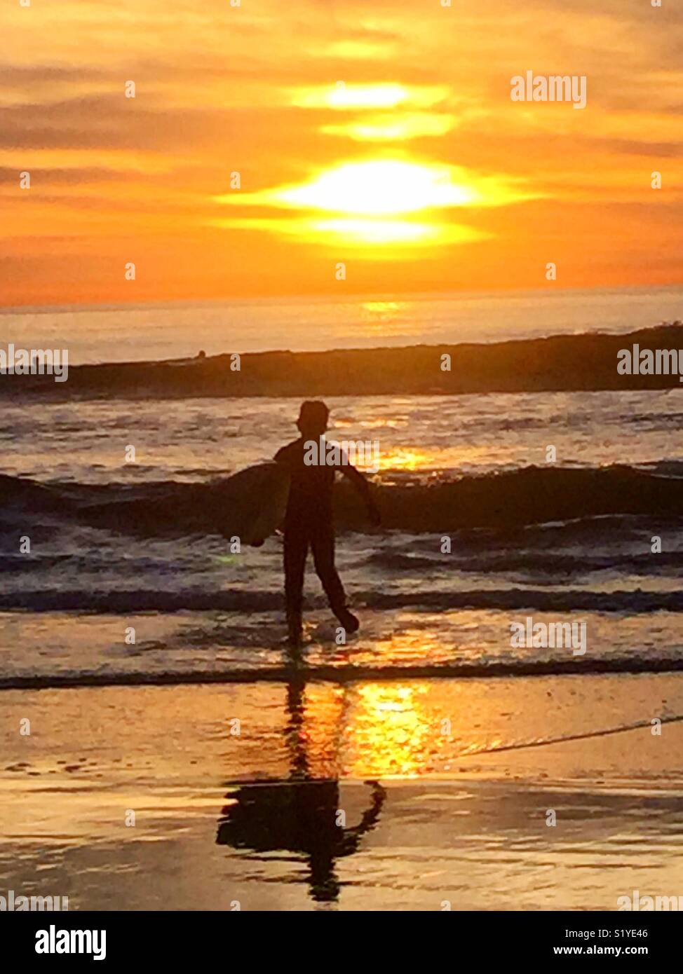 Boy playing in ocean Stock Photo