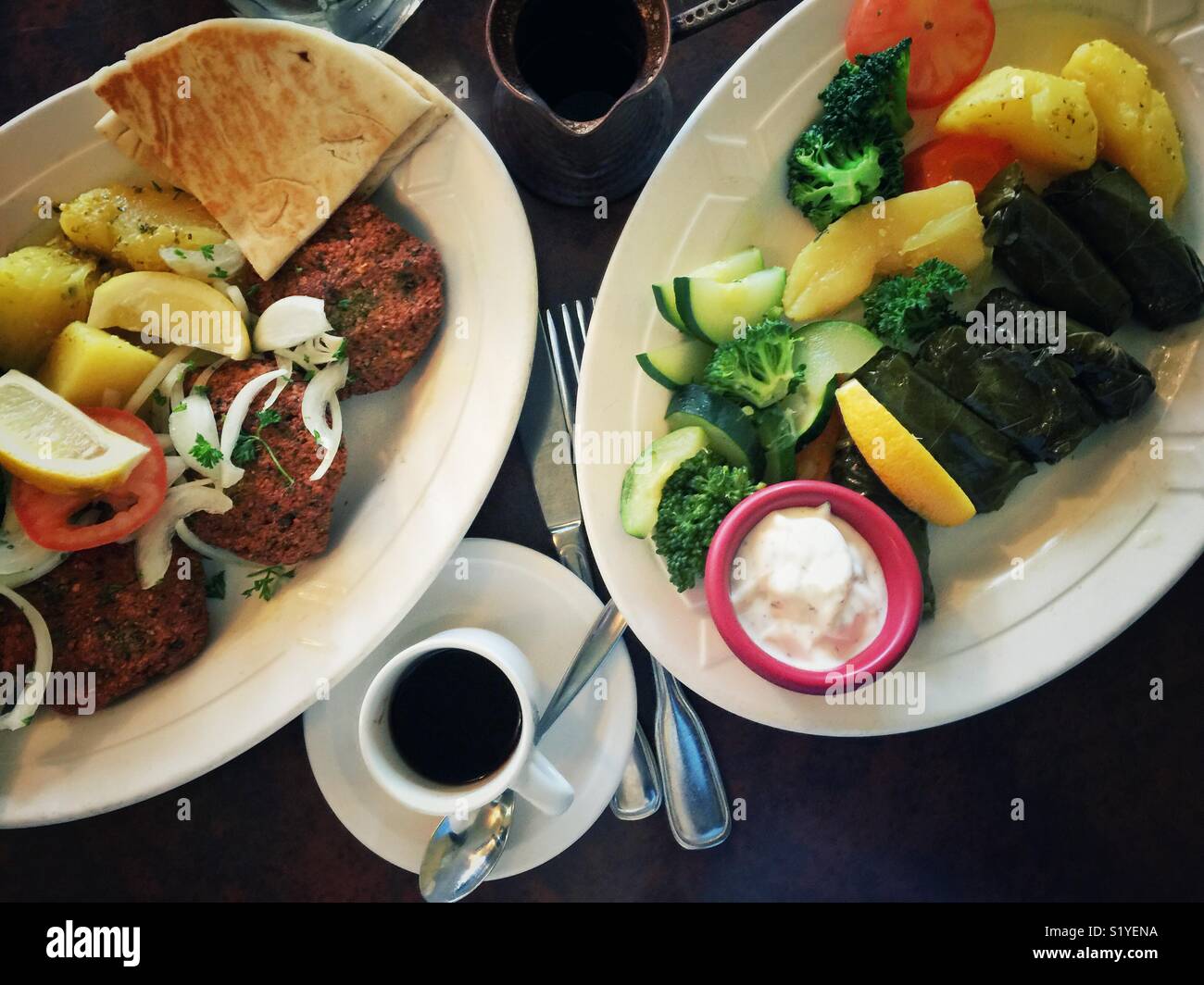 Colorful vegetarian food on two plates with coffee in Greek restaurant - Smartphone Captured Stock Image