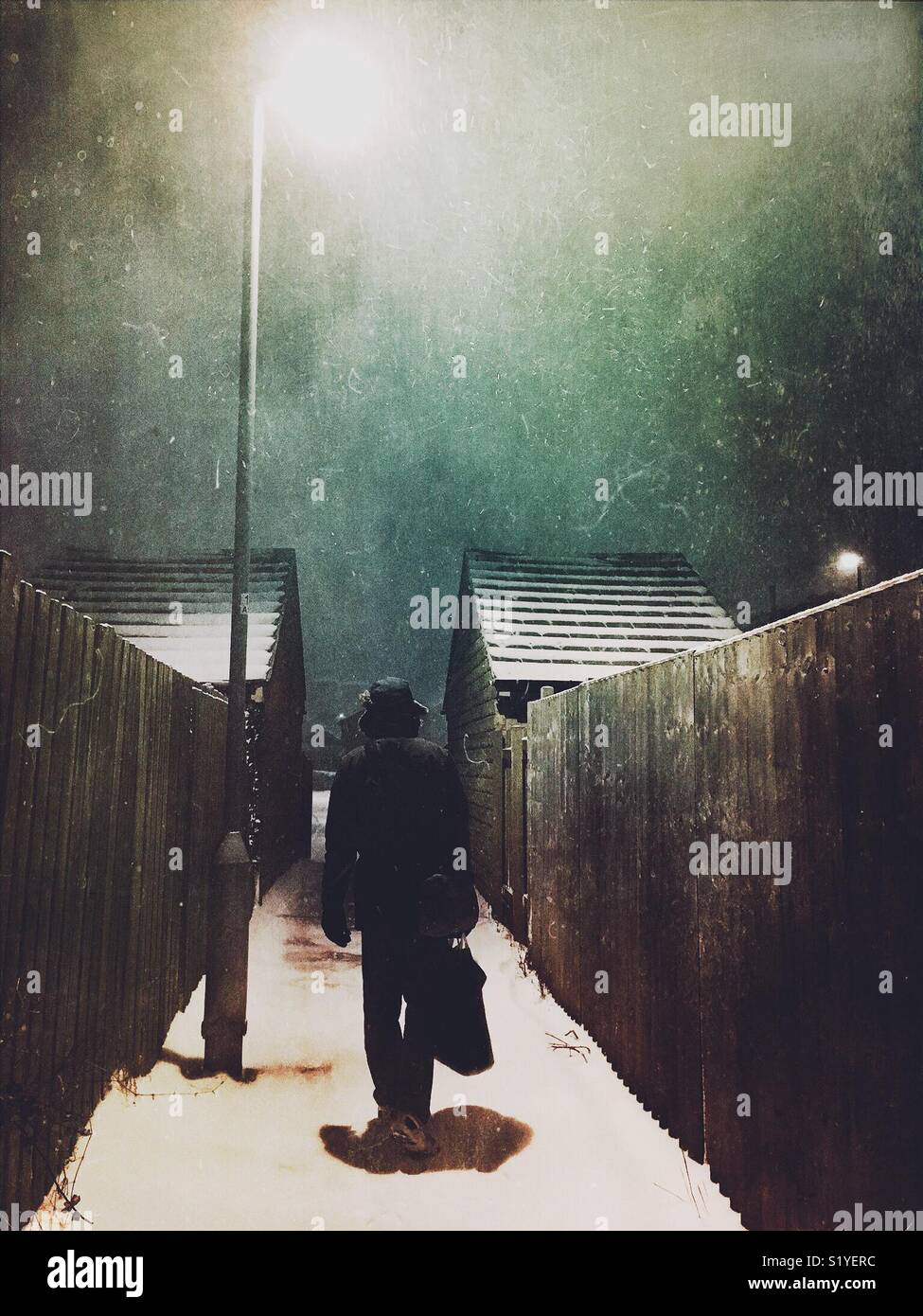 Silhouette of a man walking in an alleyway - Smartphone Captured Stock Image