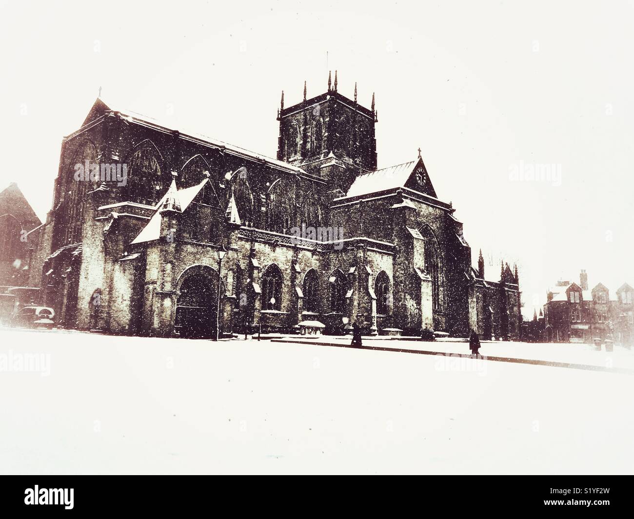 UK Weather: Sherborne, Dorset. Snow falls on Sherborne Abbey in the historic market town of Sherborne as the so called mini Beast from the East brings another icy blast to the South West. - Smartphone Captured Stock Image