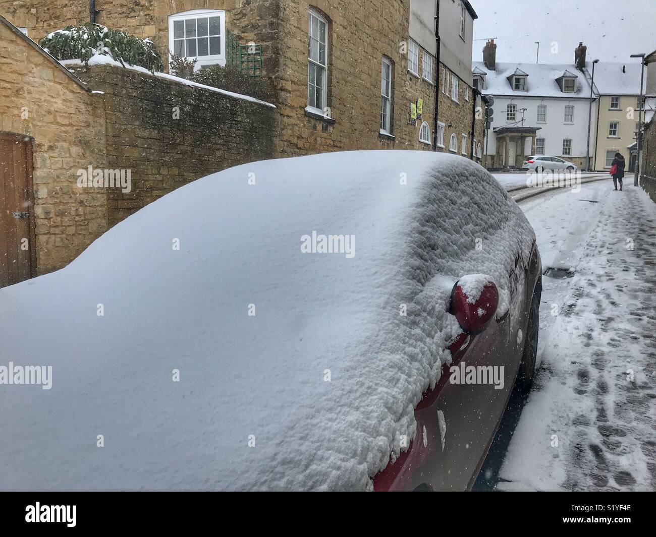 UK, Weather, Sherborne, Dorset. car covered in snow in Upper Cheap Street as the so called mini Beast from the East brings another icy blast to the South West. - Smartphone Captured Stock Image