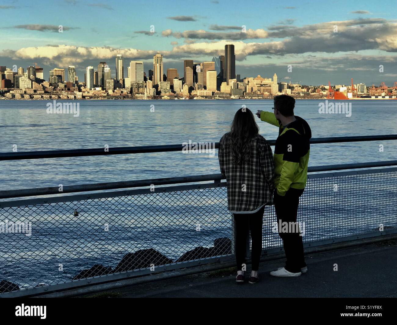 Watching sunset on downtown Seattle across Elliot Bay, Washington - Smartphone Captured Stock Image