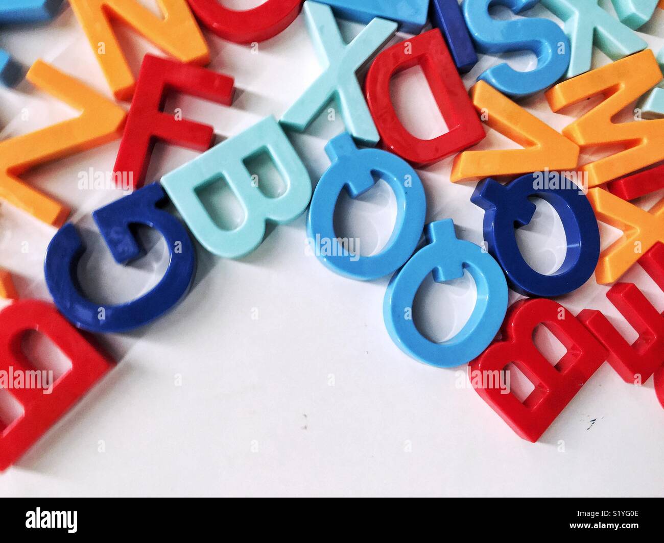mixed up colorful magnetic letters with empty space for copy - Smartphone Captured Stock Image