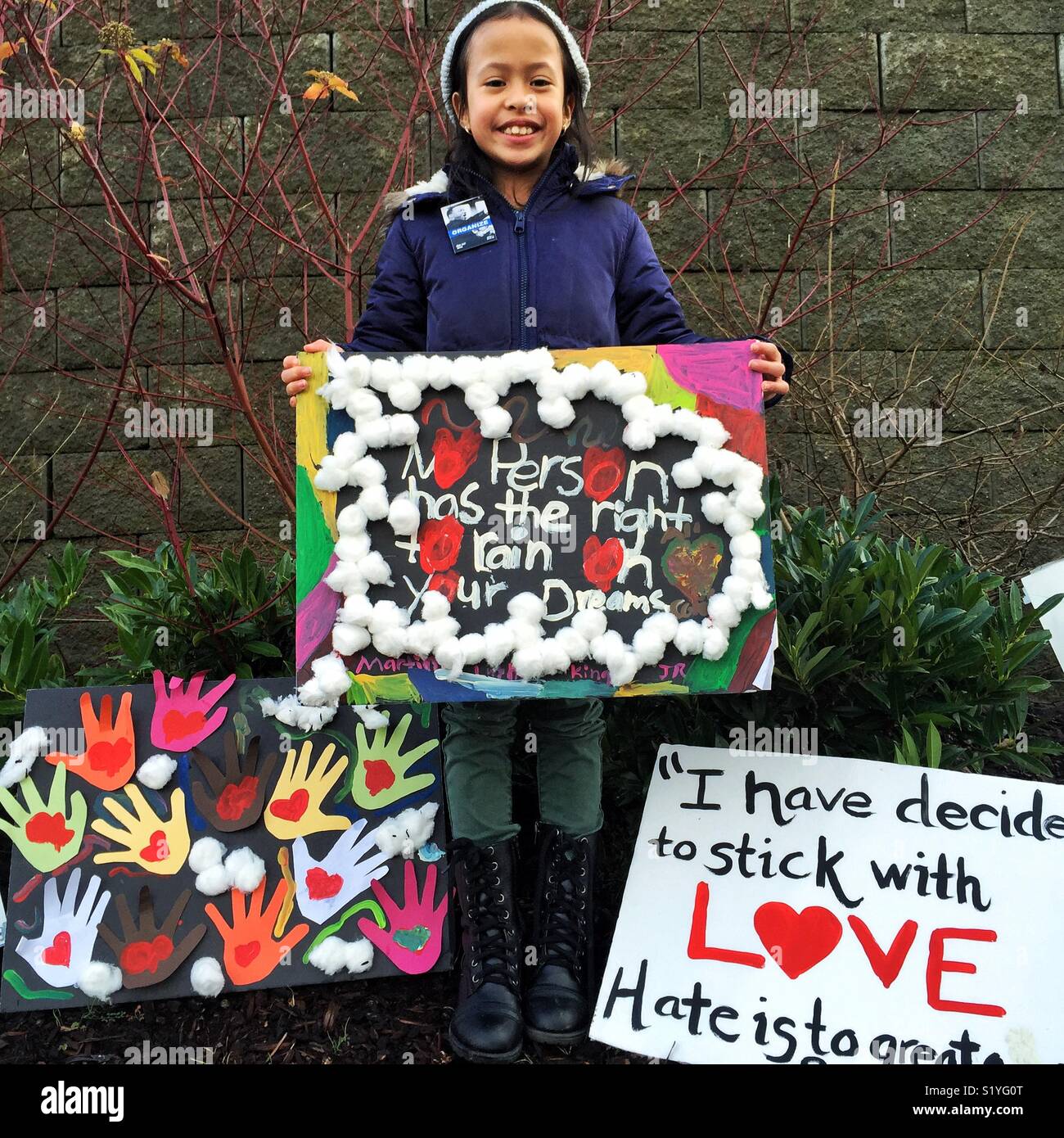 African-American girl holding homemade protest sign during Dr. MLK Jr. march in Seattle - Smartphone Captured Stock Image