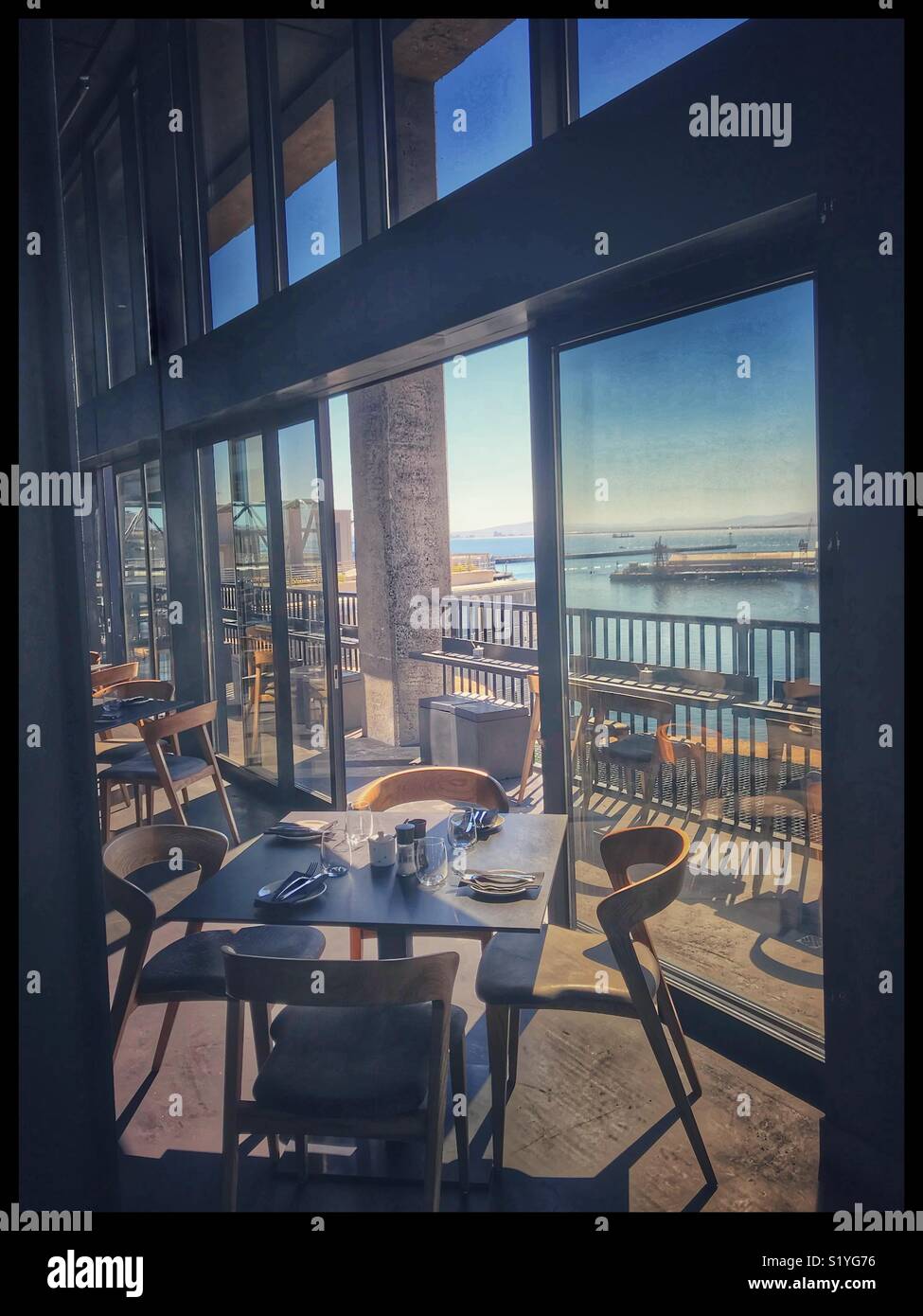 The newly opened Zeitz MOCAA Food restaurant and bar in the Zeitz Museum, Cape Town, South Africa with its view of the harbour. - Smartphone Captured Stock Image