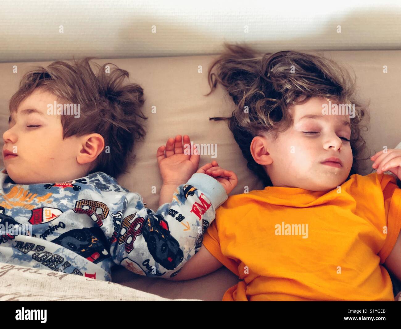 Sibling sleeping together in the same bed - Smartphone Captured Stock Image