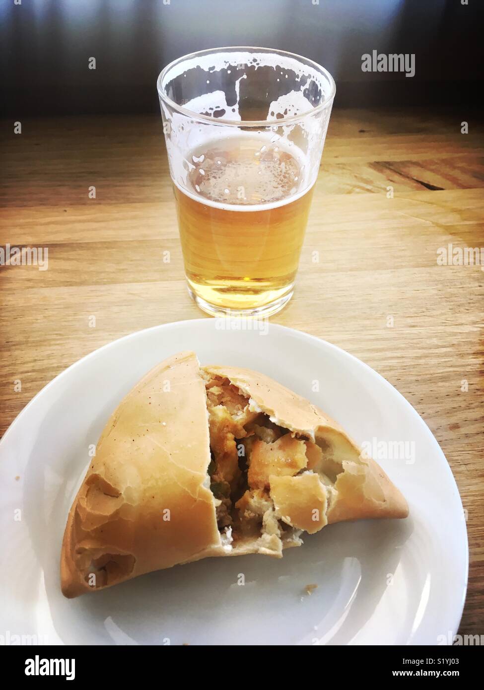 Argentinian pastry served with beer - Smartphone Captured Stock Image