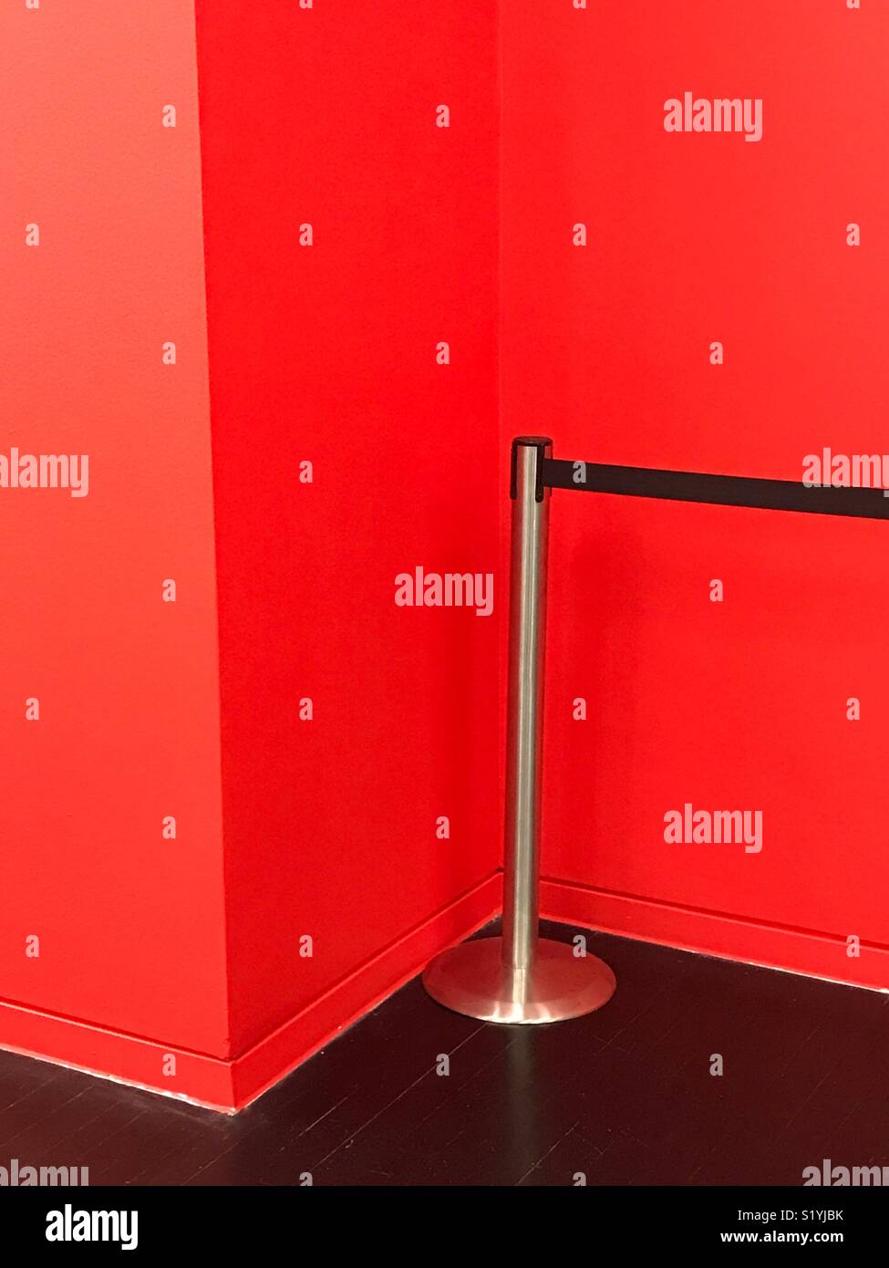 A barrier and a red wall - Smartphone Captured Stock Image