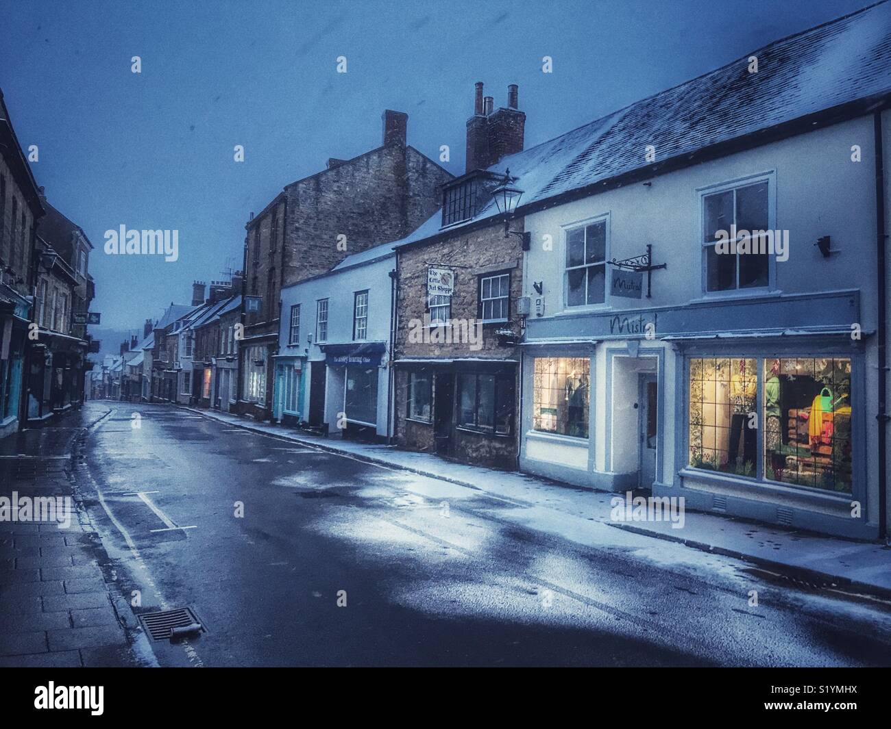 View down Cheap Street at dawn, with snow on the ground and a blizzard just starting, Beast from the East, Sherborne, Dorset, England, March 2018 - Smartphone Captured Stock Image