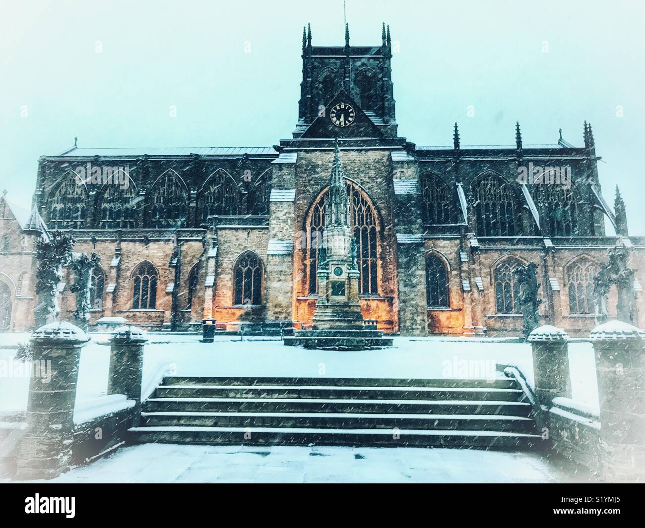 Sherborne Abbey, floodlit, dawn, with snow on the ground and a blizzard just starting, Beast from the East, Sherborne, Dorset, England, March 2018 - Smartphone Captured Stock Image