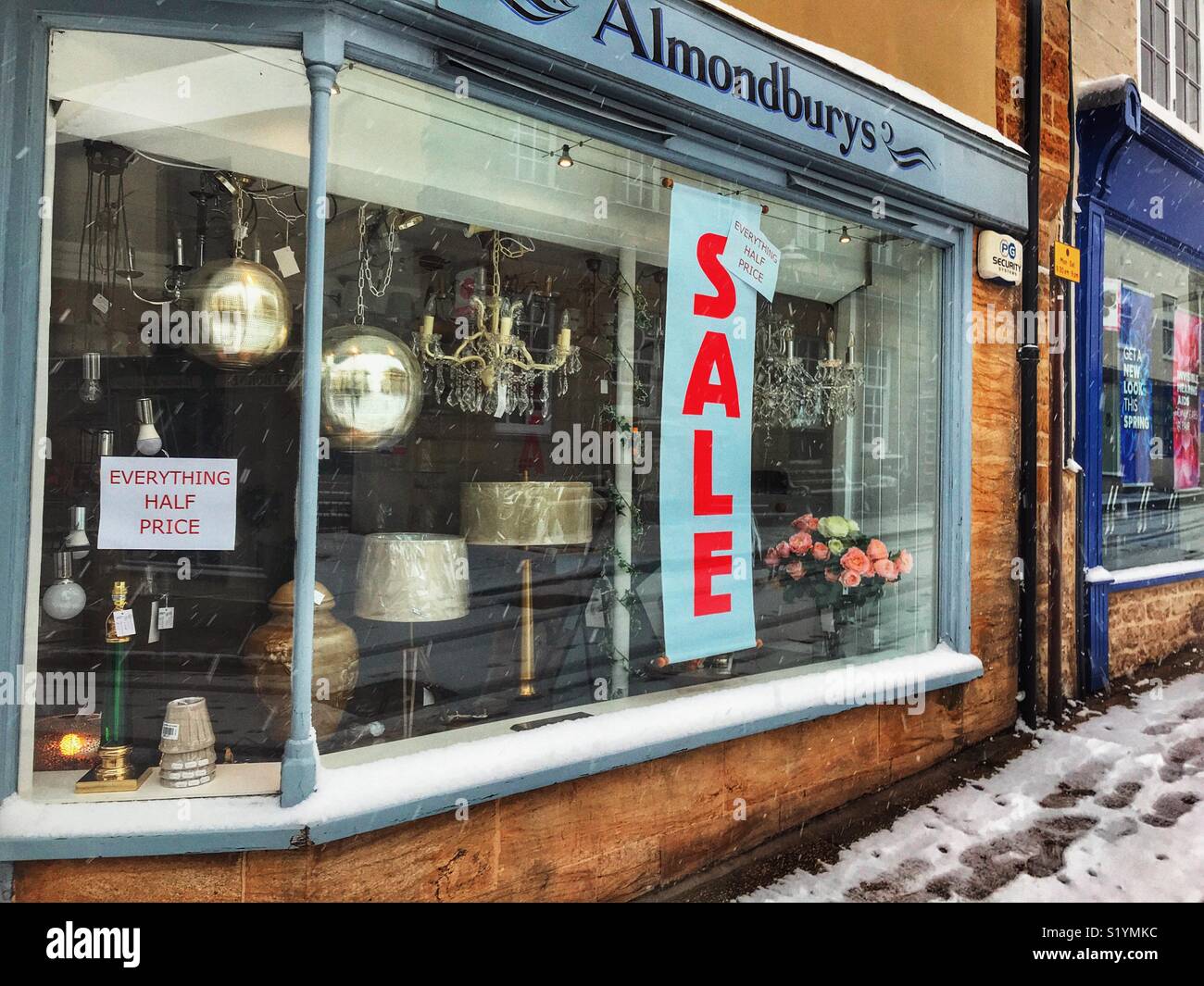 Almondsbury shop facade with sale sign, Cheap Street, with snow during a blizzard, Beast from the East, Sherborne, Dorset, England, March 2018 - Smartphone Captured Stock Image