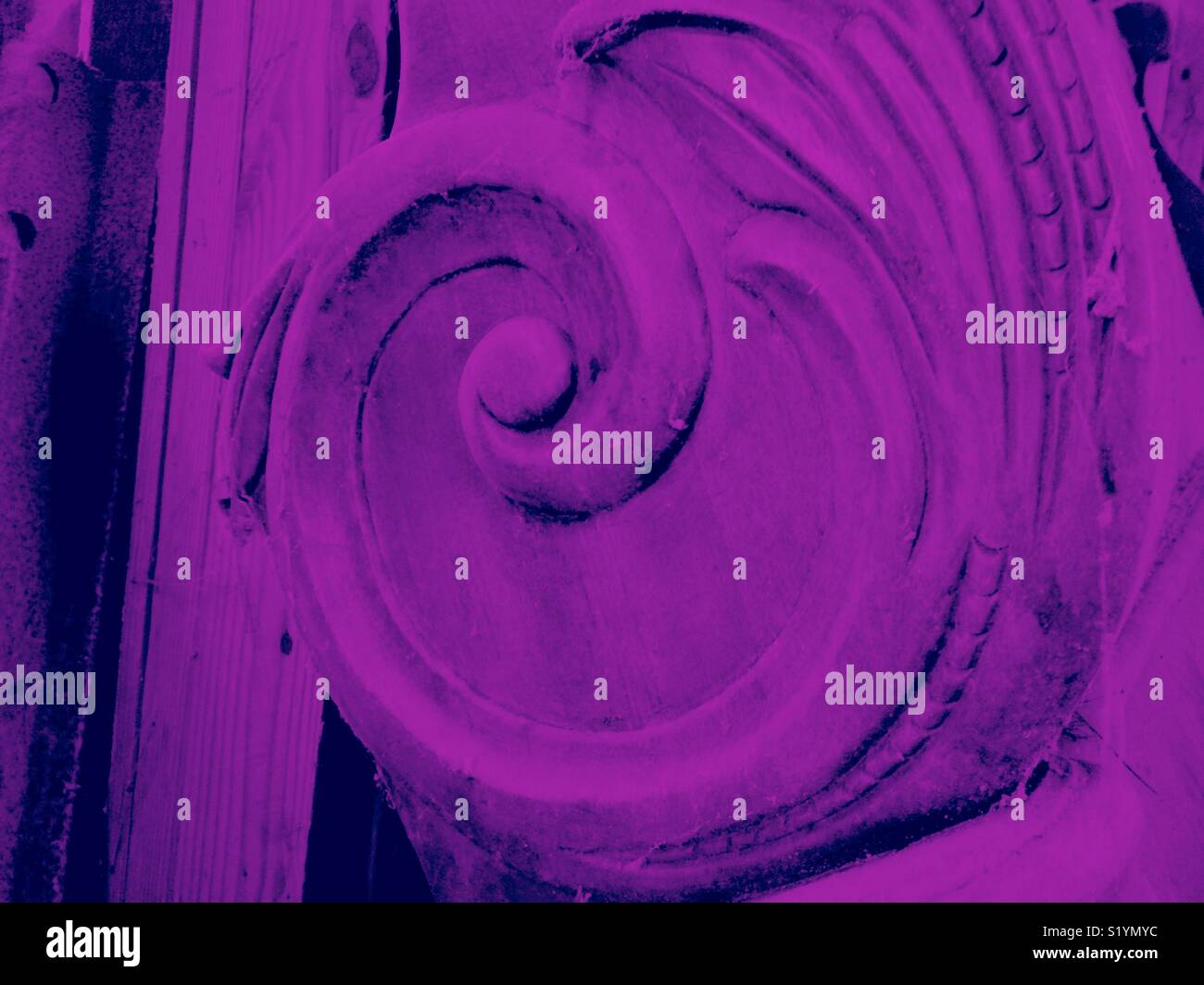 Purple filtered photo of scroll detail on ornate footboard - Smartphone Captured Stock Image