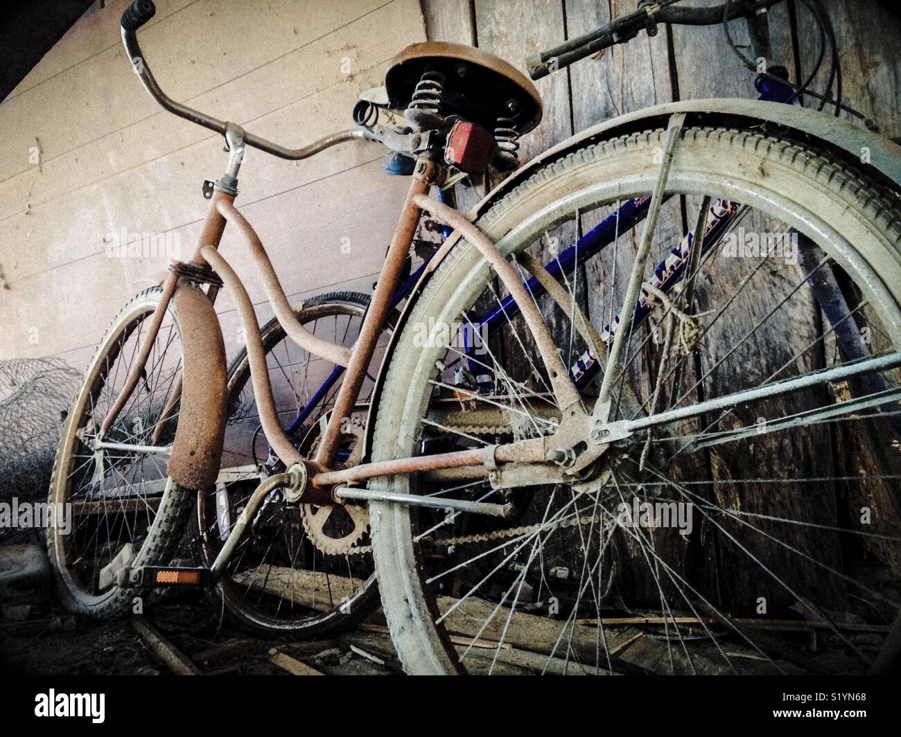 Two old bicycles stored with the chicken wire in the shed - Smartphone Captured Stock Image