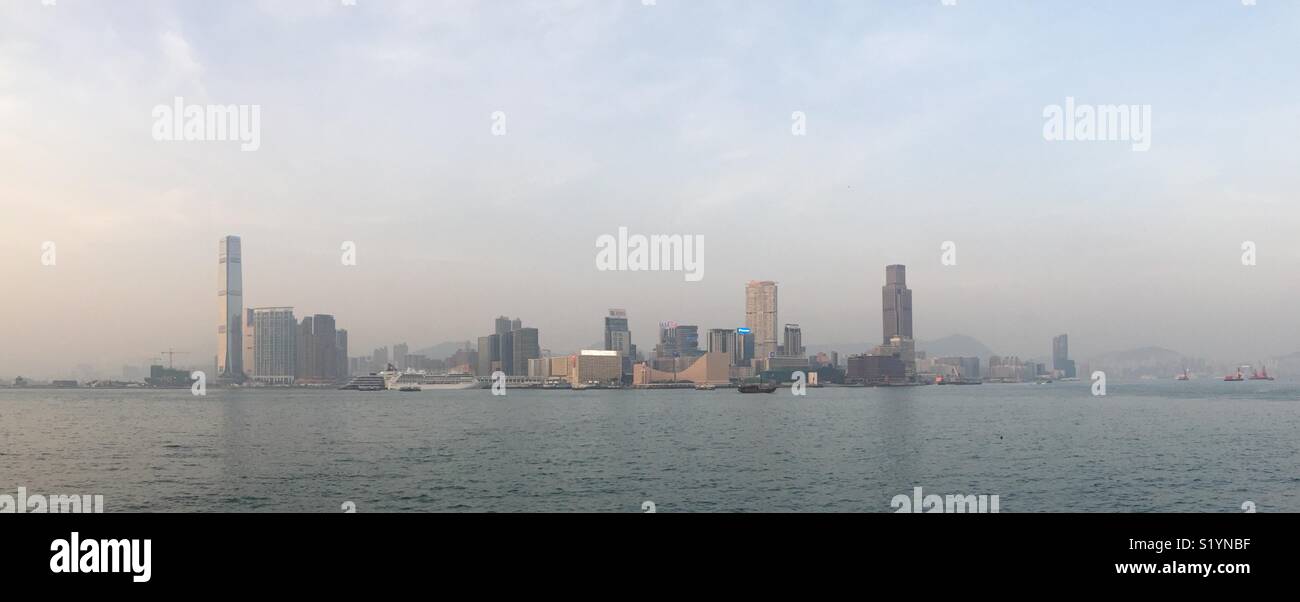 Panorama of West Kowloon, Tsim Sha Tsui, Hung Hom and Victoria Harbour, viewed from Tamar Park, Admiralty, Central, Hong Kong Island, at twilight - Smartphone Captured Stock Image
