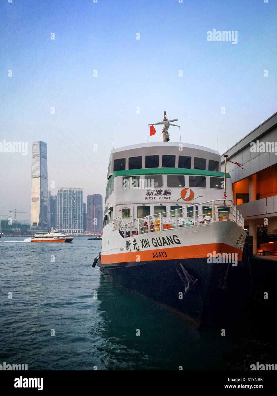 The ‘Xin Guang’, a triple-decker ferry operated by New World First Ferry Services between Central Piers on Hong Kong Island and the Outlying Island of Cheung Chau - Smartphone Captured Stock Image The ‘Xin Guang’, a triple-decker ferry operated by New World First Ferry Services between Central Piers on Hong Kong Island and the Outlying Island of Cheung Chau - Smartphone Captured Stock Image