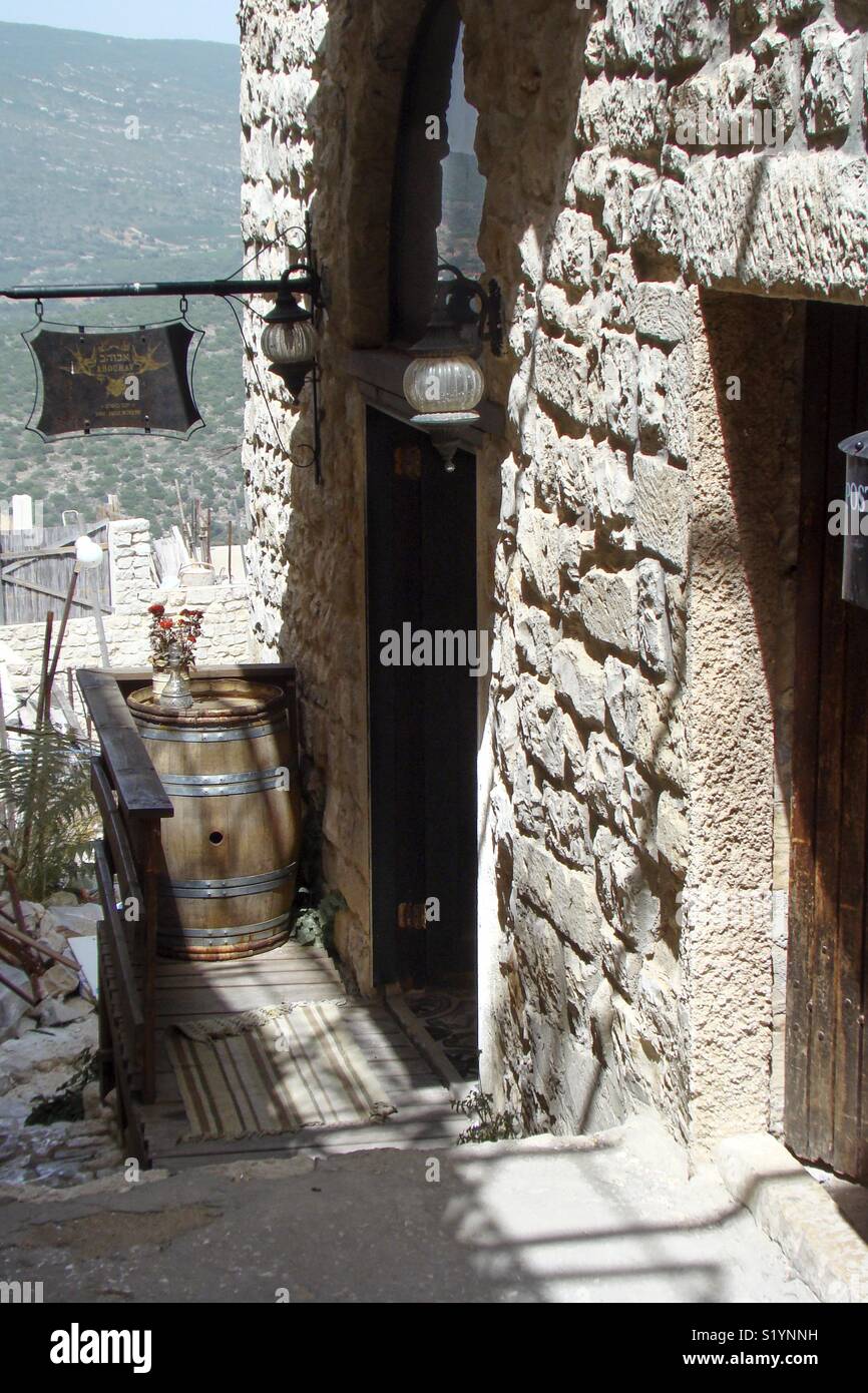 View in a historic street in the Israeli city of Safed with an old wine barrel Stock Photo