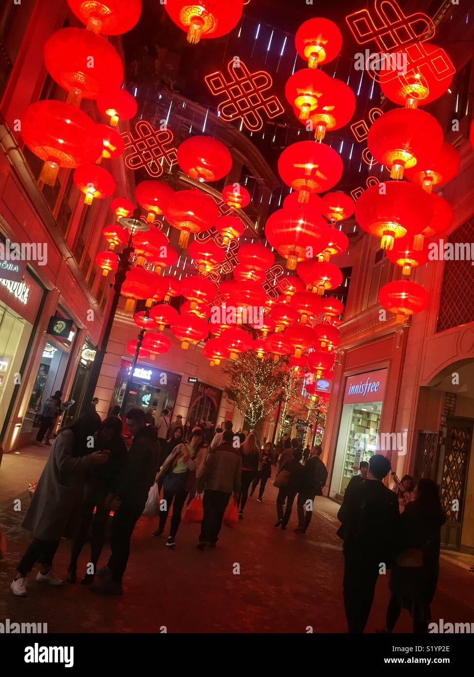 Red lanterns, traditional decorations for Chinese New Year, in Lee Tung Avenue, a shopping mall opened in 2015 on the site of old Lee Tung Street (‘Wedding Card Street’) in Wan Chai, Hong Kong - Smartphone Captured Stock Image