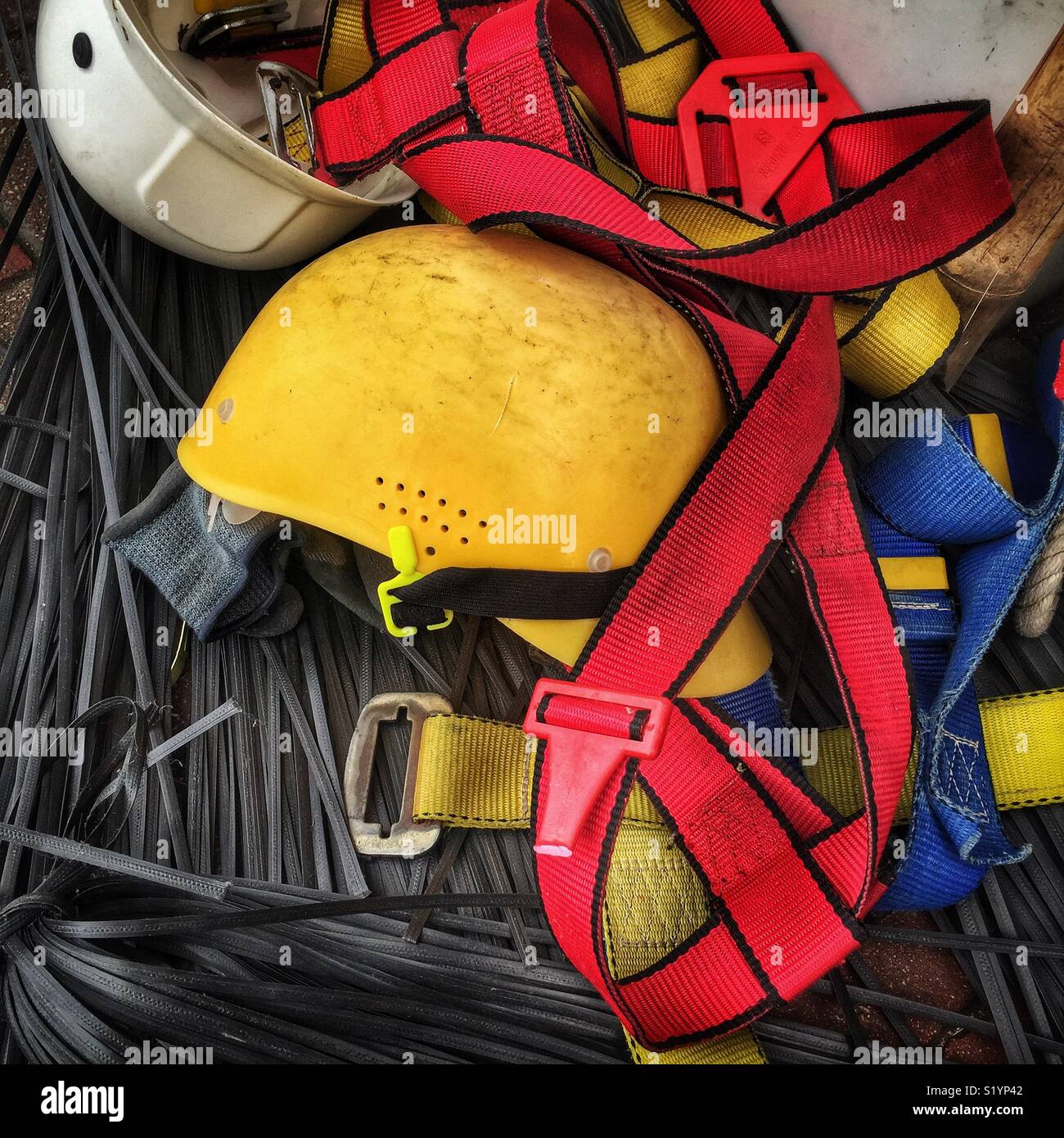 Safety helmets, harnesses and plastic ties used to construct bamboo scaffolding, Wan Chai, Hong Kong Island - Smartphone Captured Stock Image