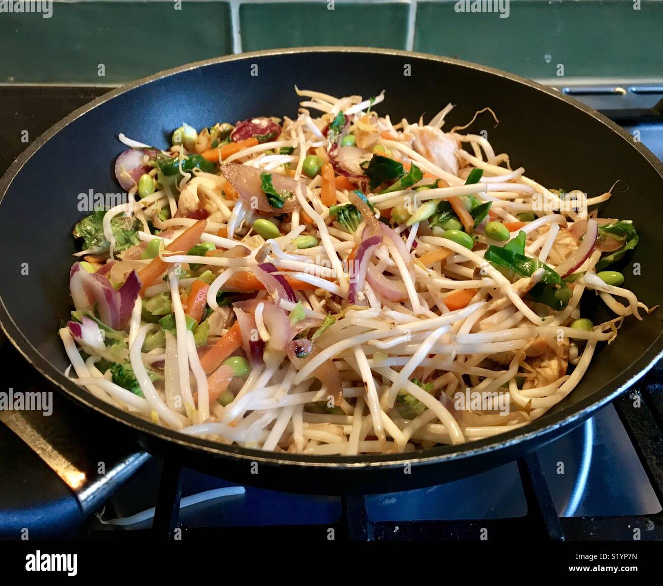 Colourful stir fry cooking in a wok Stock Photo - Alamy