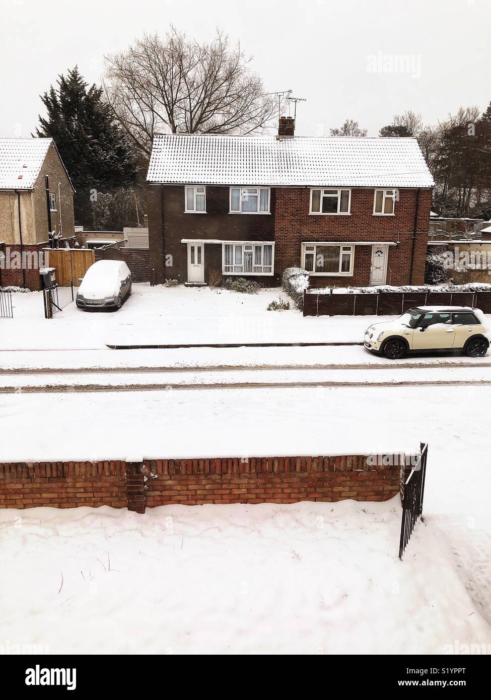 Looking down at a snowy scene, the street below. - Smartphone Captured Stock Image