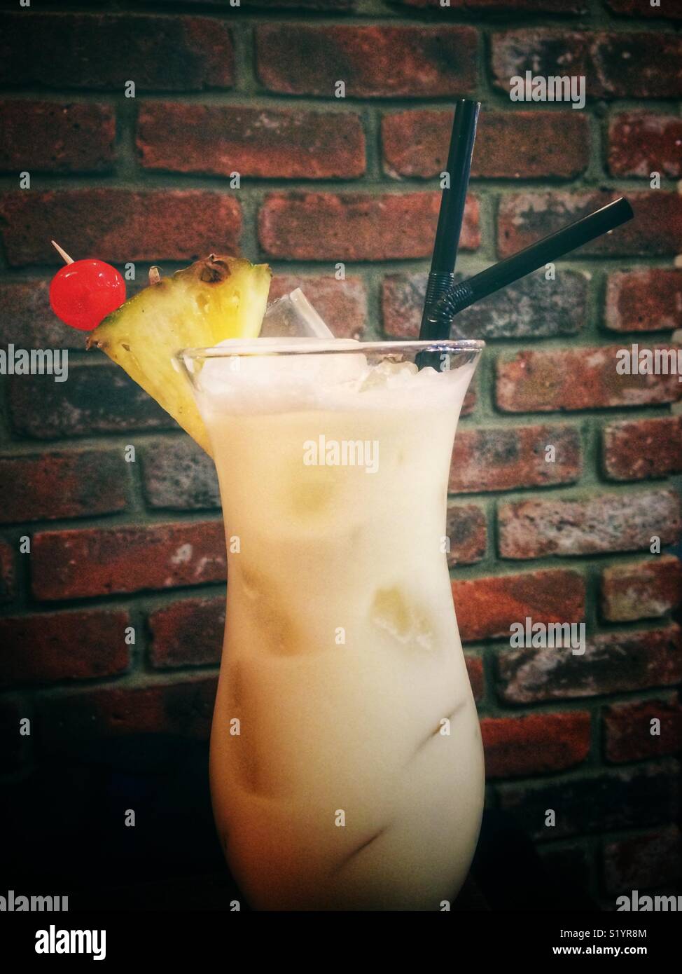 Pina colada cocktail in a glass with ice cubes - Smartphone Captured Stock Image