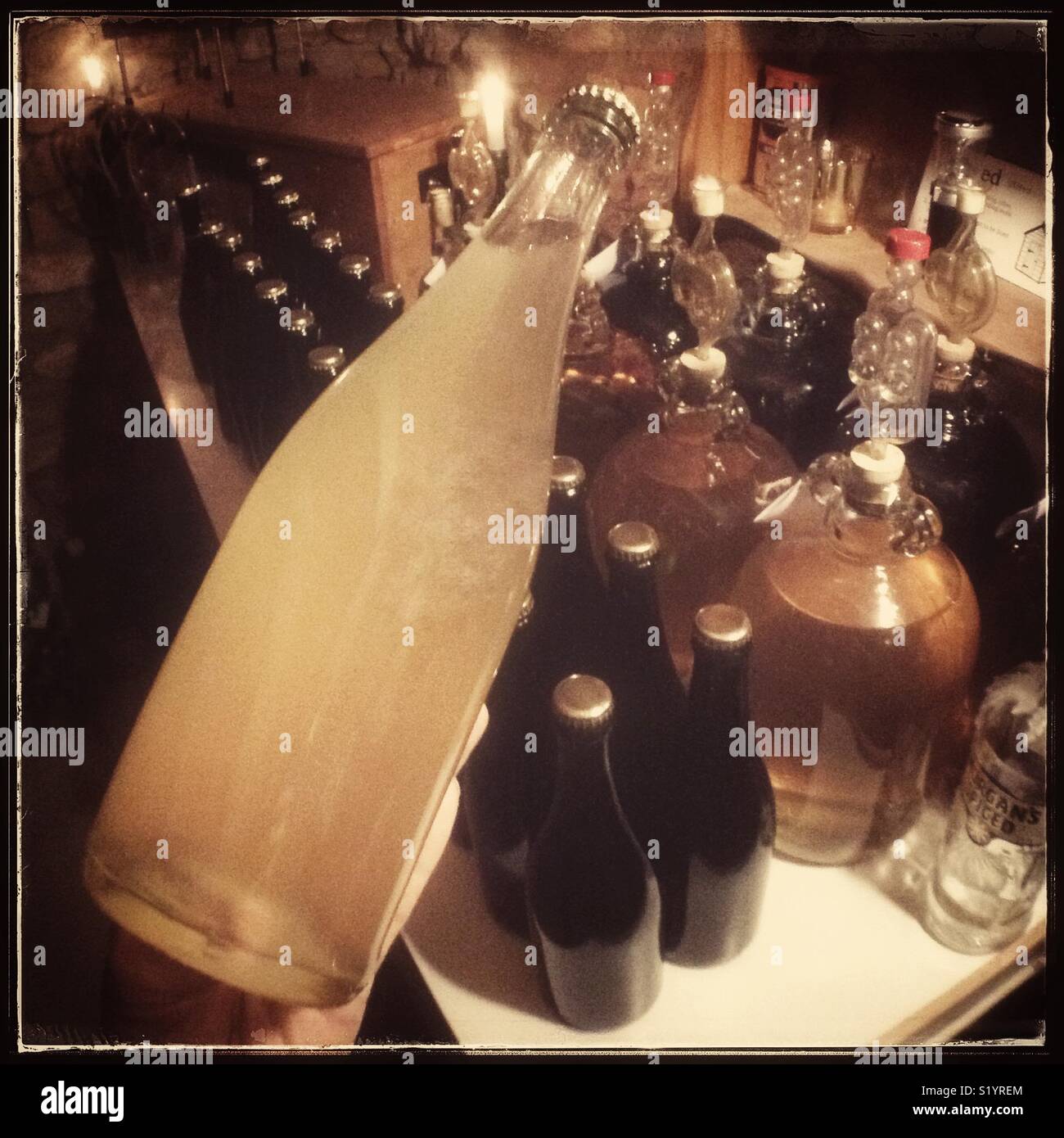 Inoculating homemade Macabeo sparkling wine with yeast for a bottle fermentation, Catalonia, Spain. - Smartphone Captured Stock Image