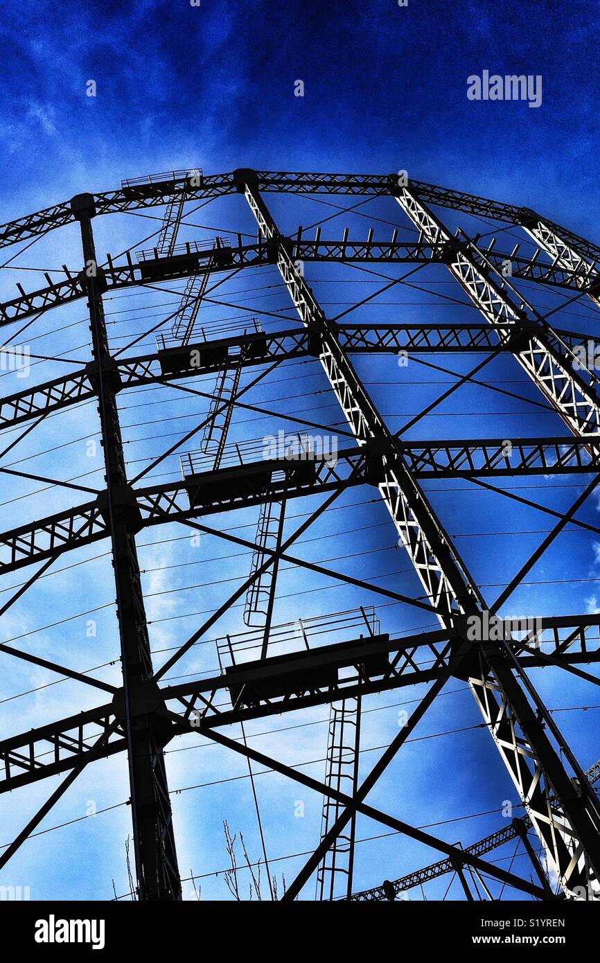Detail of ladders on empty gasometer structure against a blue sky - Smartphone Captured Stock Image