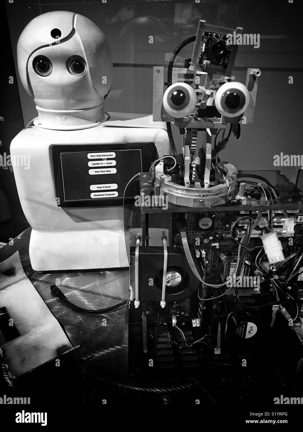Two robots at the AI exhibit at MIT Museum in Boston. May 2017. In black and white. Stock Photo