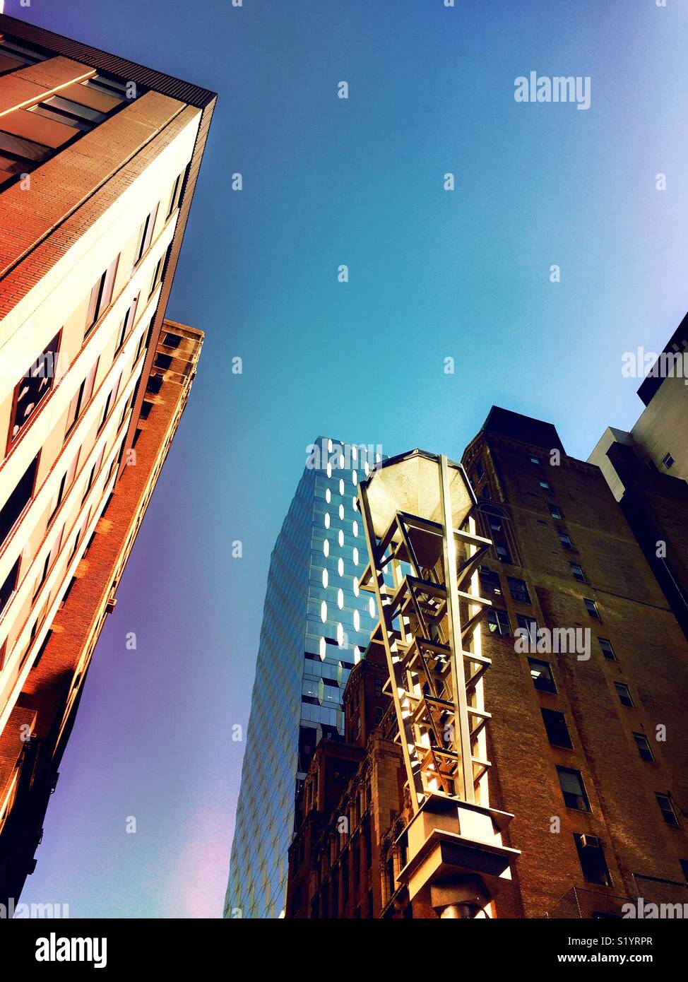 Diamond district light stanchion and skyscrapers at the intersection of W. 47th St. and 6th Avenue, New York City, USA - Smartphone Captured Stock Image