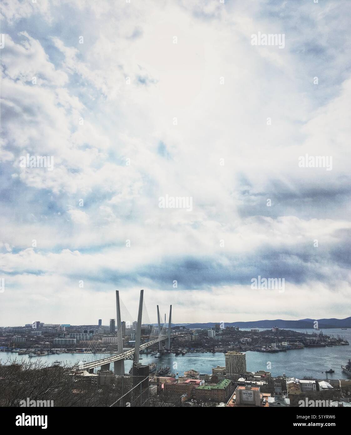 Vertical panorama of Vladivostok, Russia on March 28,2018. The Golden Bridge and Russian Island. - Smartphone Captured Stock Image