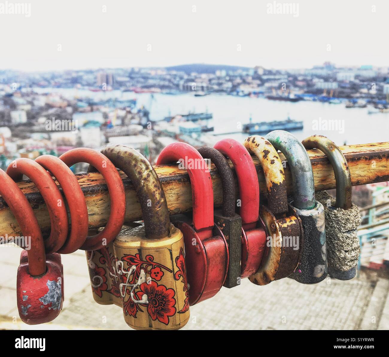 Love locks and city overview on the background. Vladivostok, Russia - Smartphone Captured Stock Image