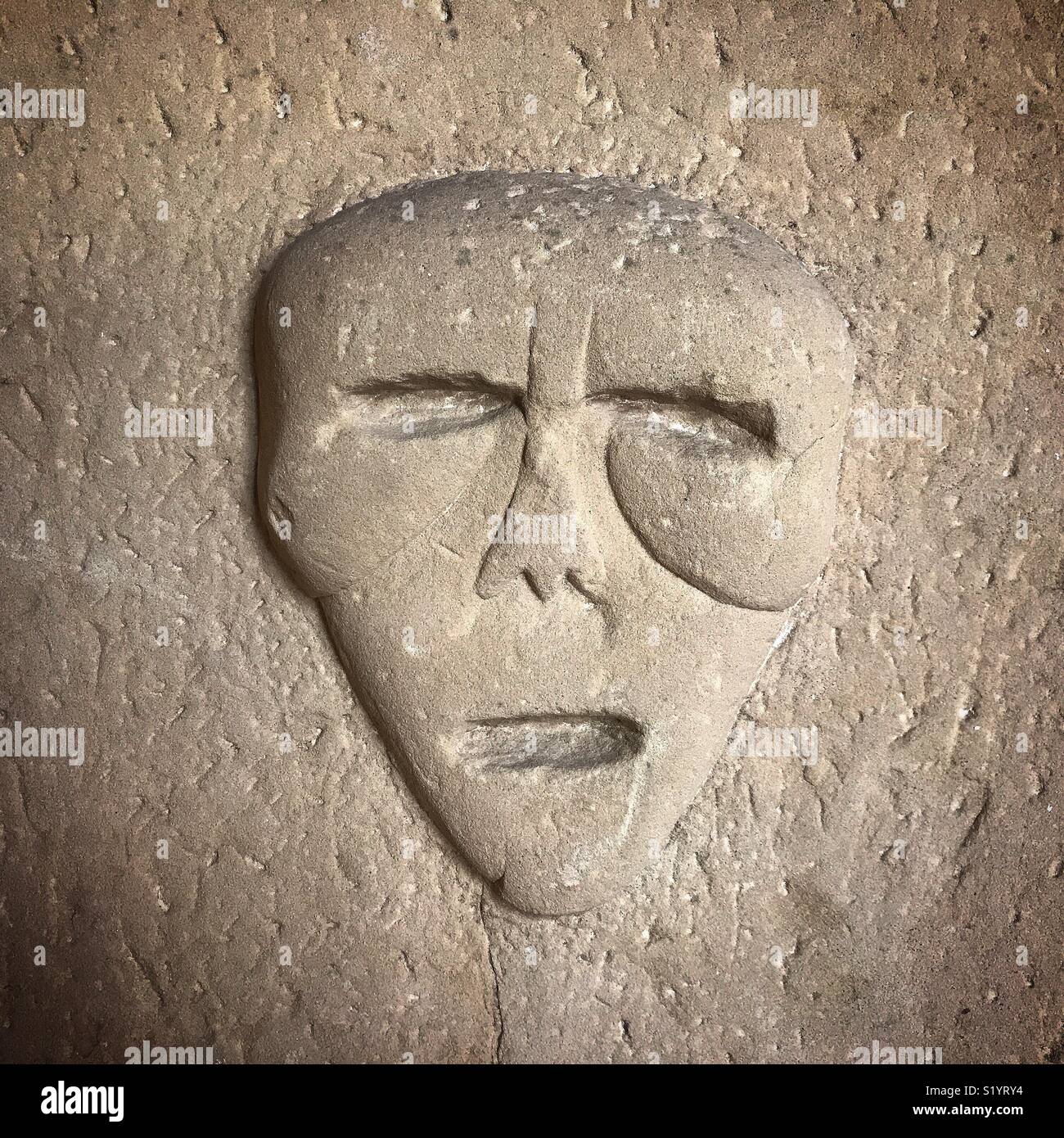 A Portuguese carving of a face of a dead person found in a colective tomb, from the XVI century, is displayed in Kashbah Museum in Tangier, Morroco, Africa - Smartphone Captured Stock Image