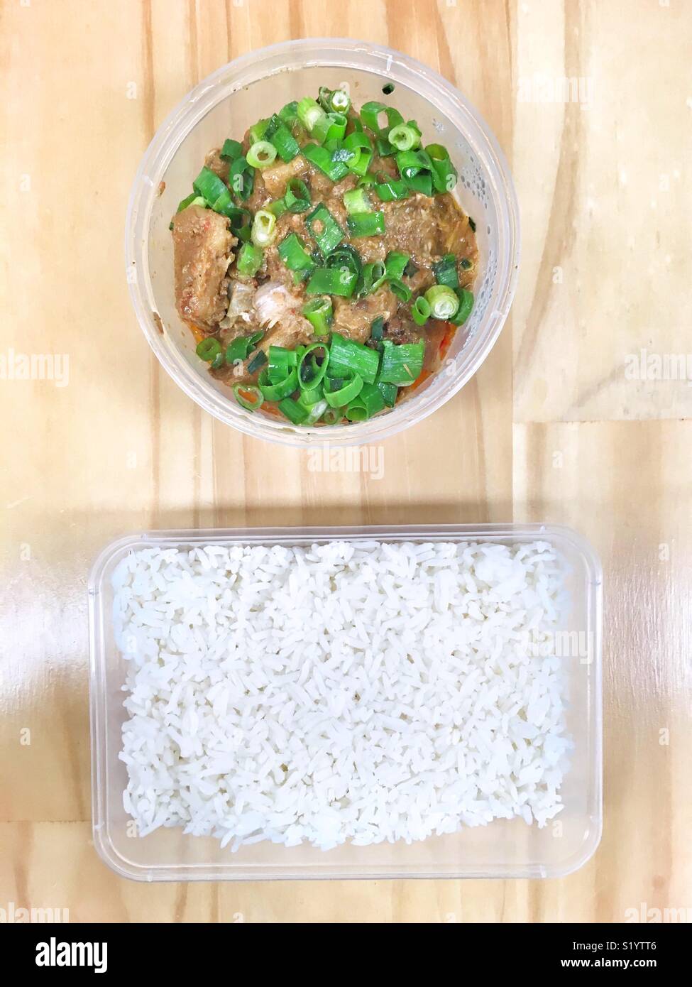Pineapple and chicken curry with white rice, in takeaway containers. - Smartphone Captured Stock Image