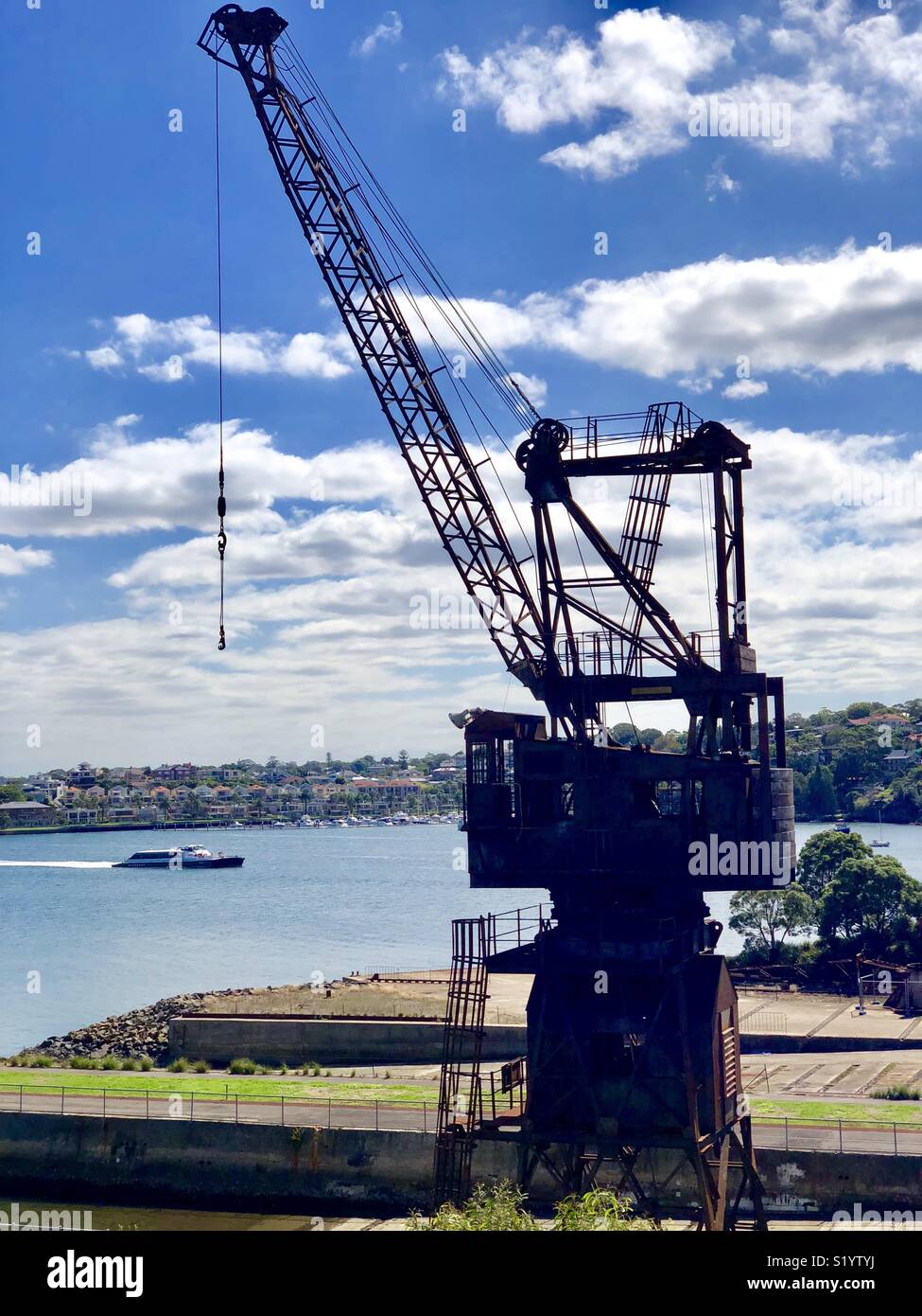 Crane and river ferry at cockatoo island Australia Stock Photo