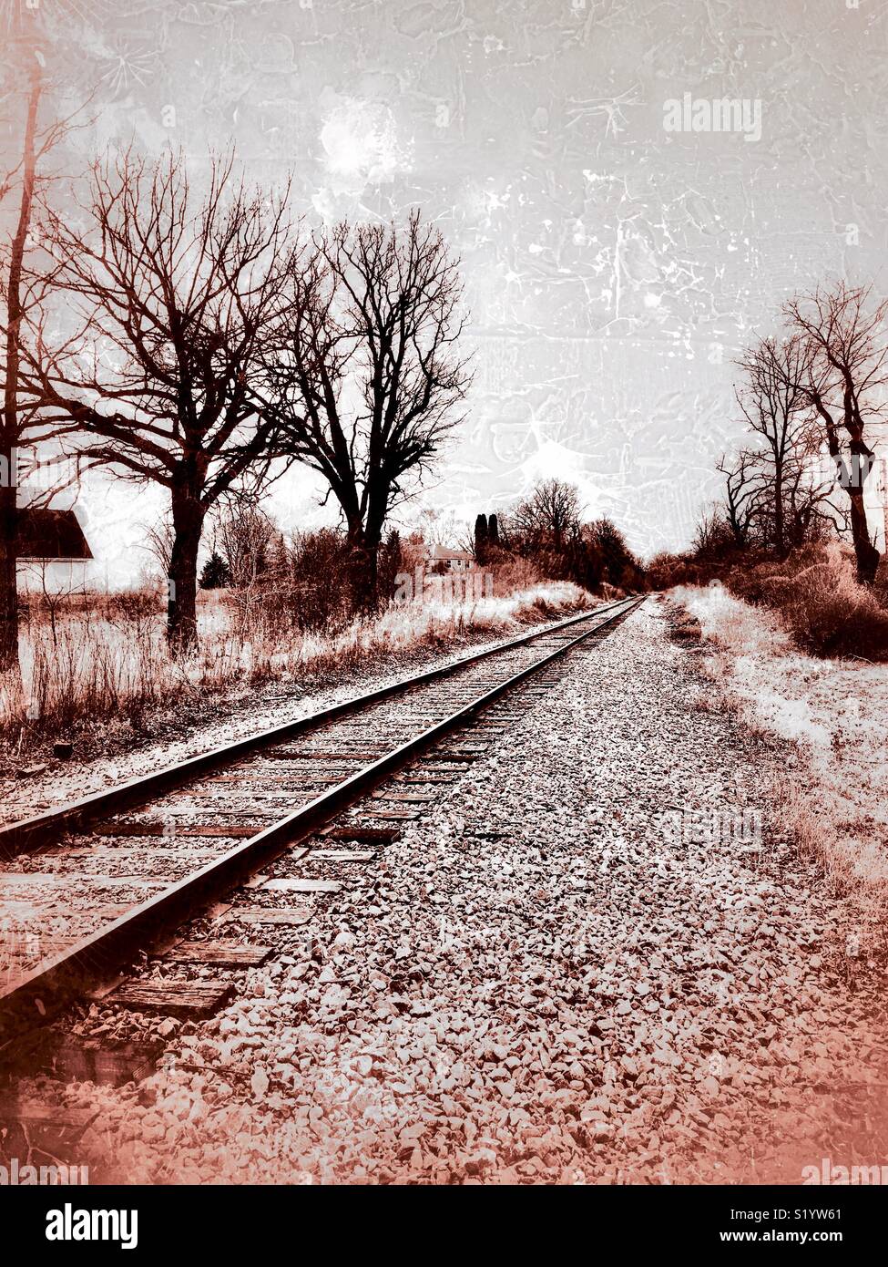 Railroad tracks in rural Wisconsin with trees and farm house - Smartphone Captured Stock Image