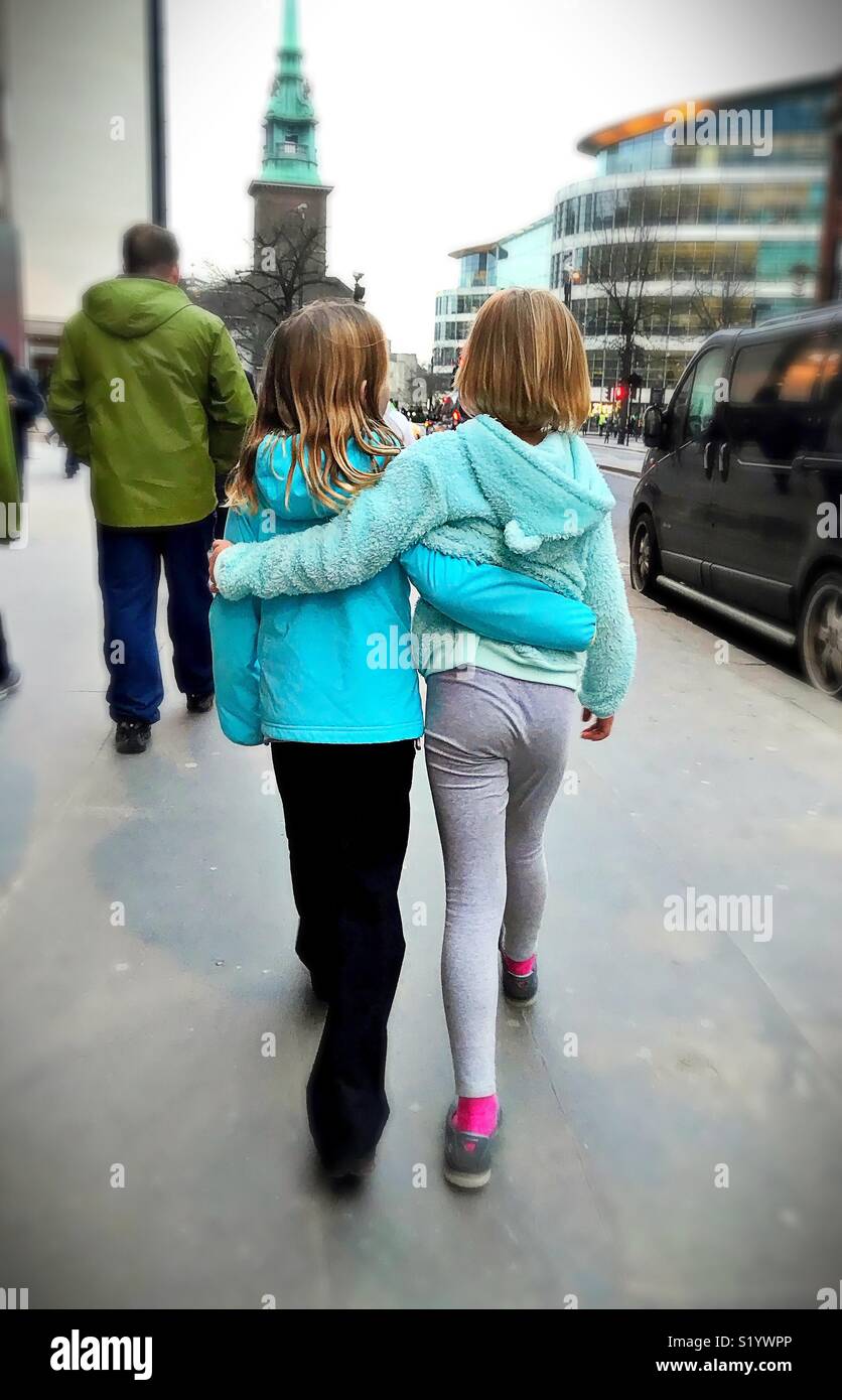 Sisters walk through London on a winter evening. - Smartphone Captured Stock Image