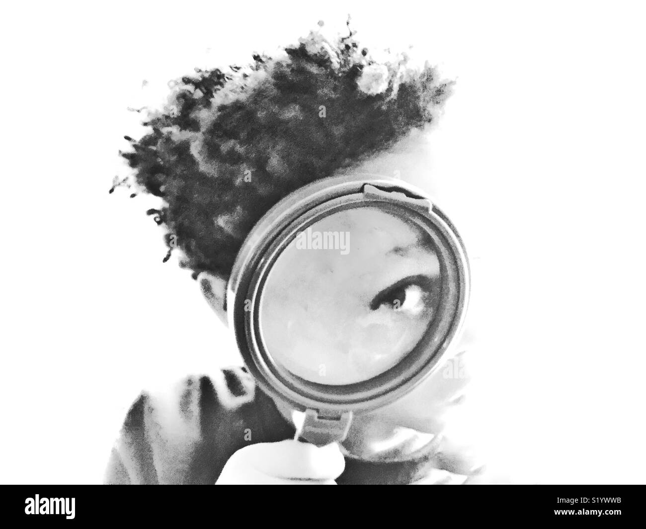 Child peering through a magnifying glass. Stock Photo