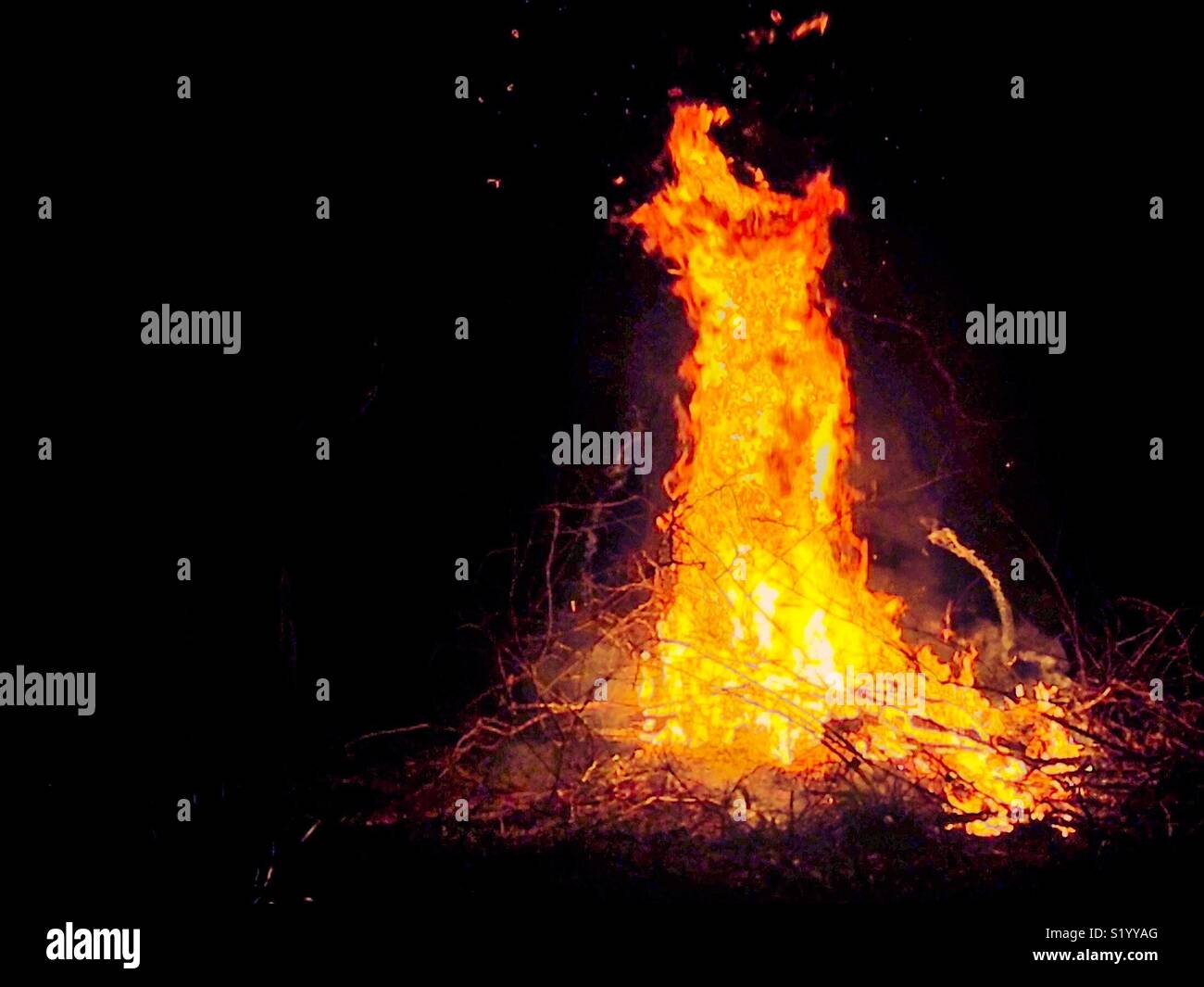 Burst of tall flames resembling evening gown Stock Photo