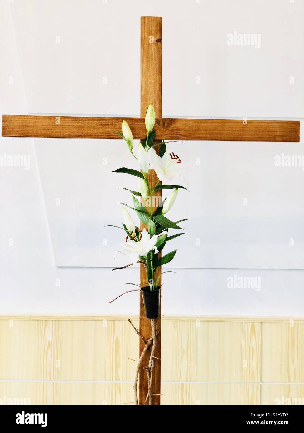 Lilies on the Easter cross Stock Photo
