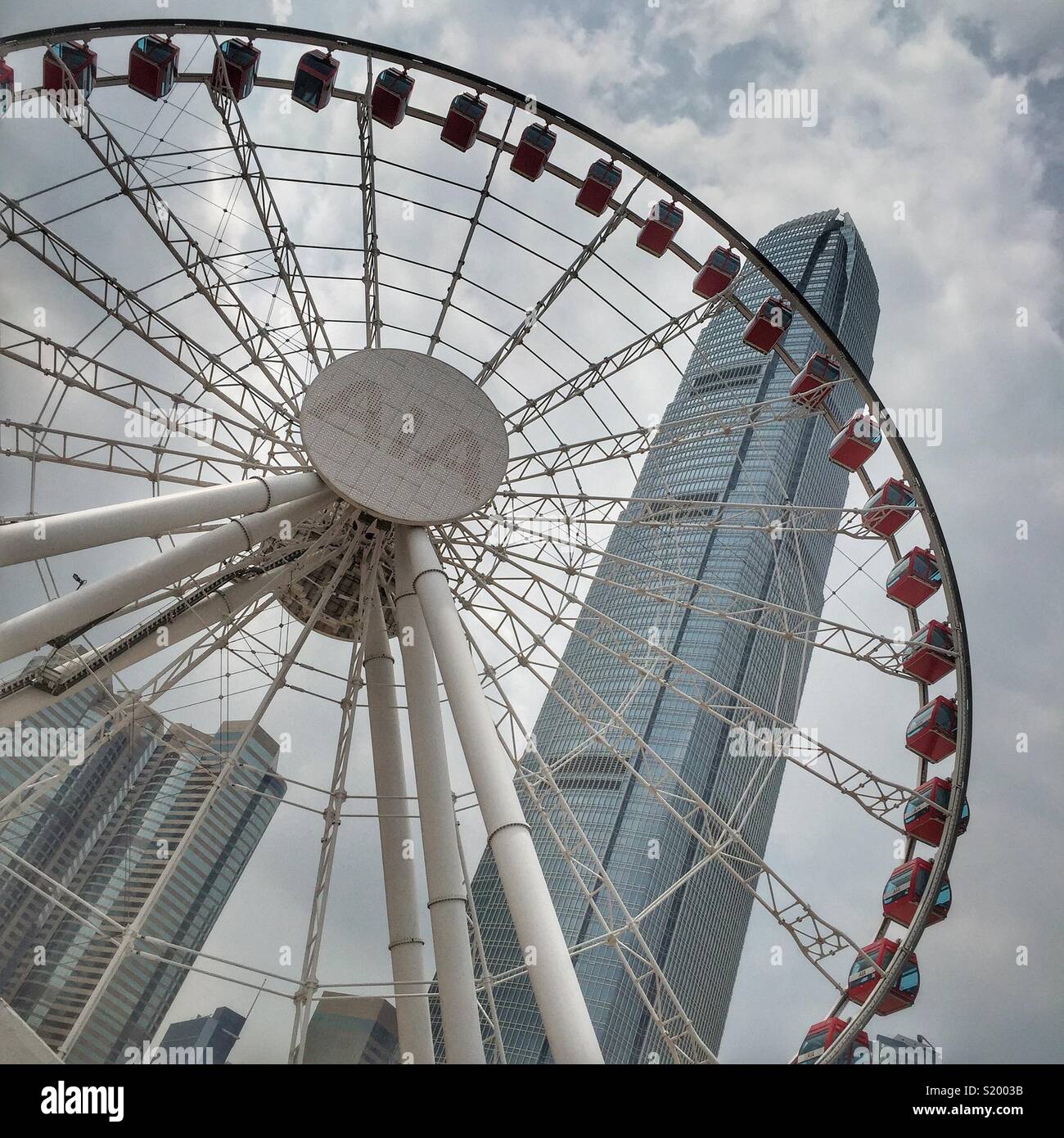 The observation wheel for tourists at the Central waterfront near Ferry Piers 9 and 10 with Hong Kong Island’s tallest building, 2ifc - Smartphone Captured Stock Image