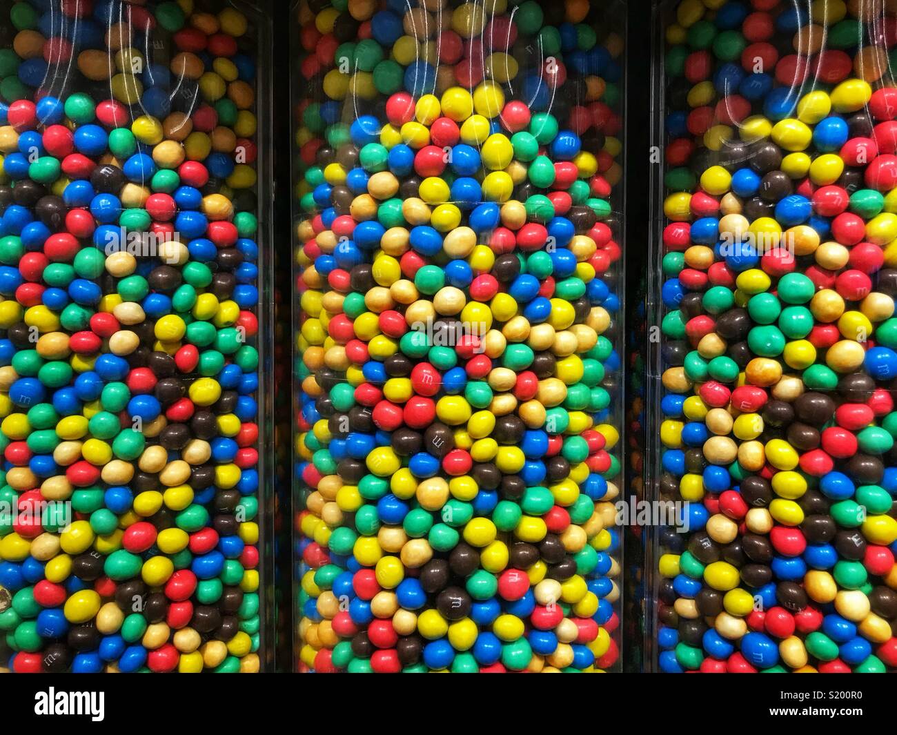 M&Ms candy in tubes at a specialty store. Stock Photo